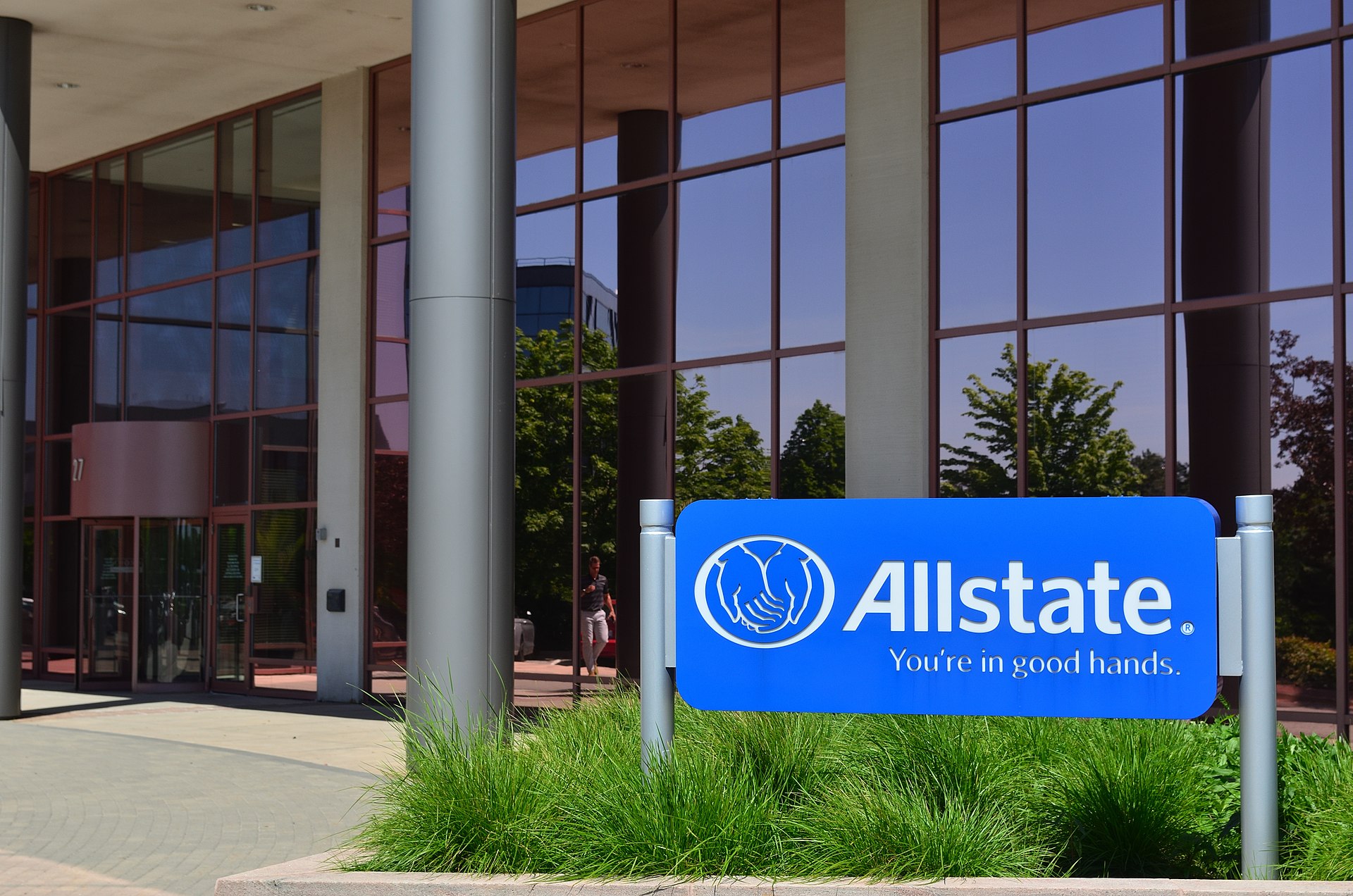 We see an Allstate sign outside of a large building.