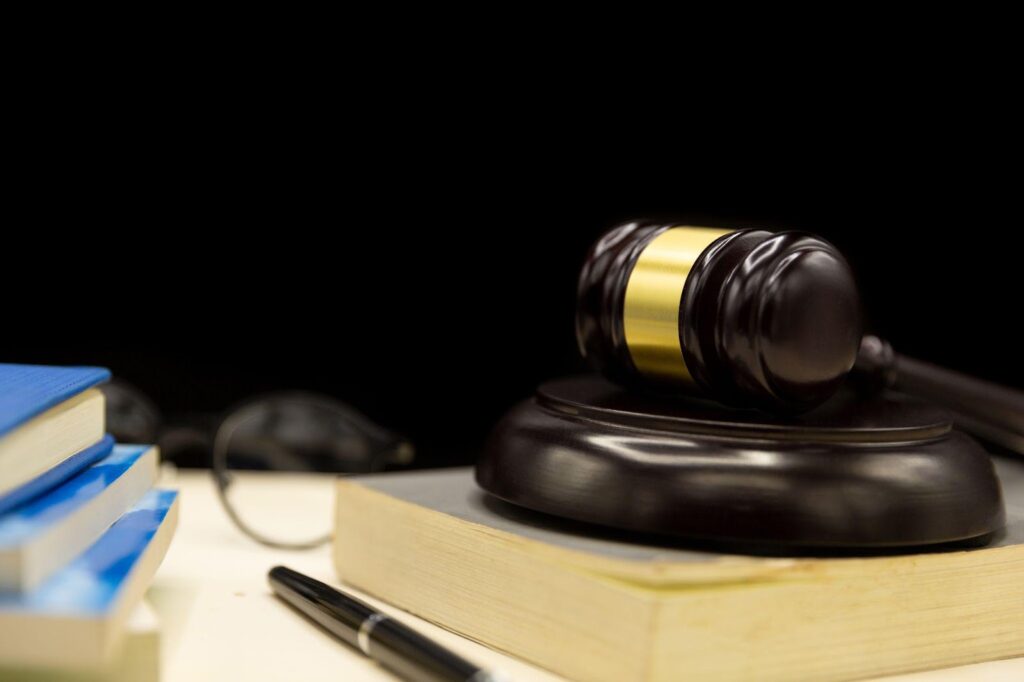 Gavel resting on stack of legal books, symbolizing law and justice in personal injury cases.