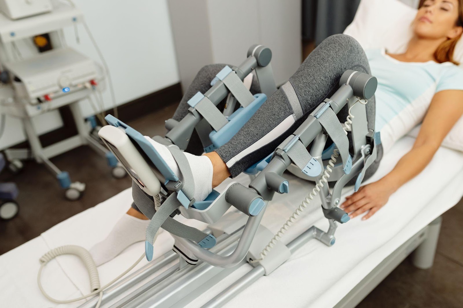 Patient is focused on extending their leg while the therapist provides support and instruction.