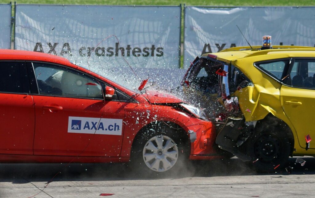 Two cars involved in a rear-end collision, with visible damage to both vehicles.