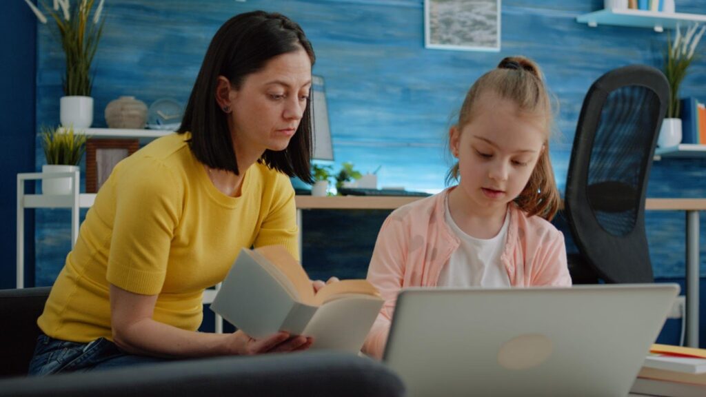 A parent and child sitting together at a table, focused on studying with books and papers in front of them. This scene reflects the adoption home study process, symbolizing the importance of a nurturing and supportive environment in preparing for adoption.