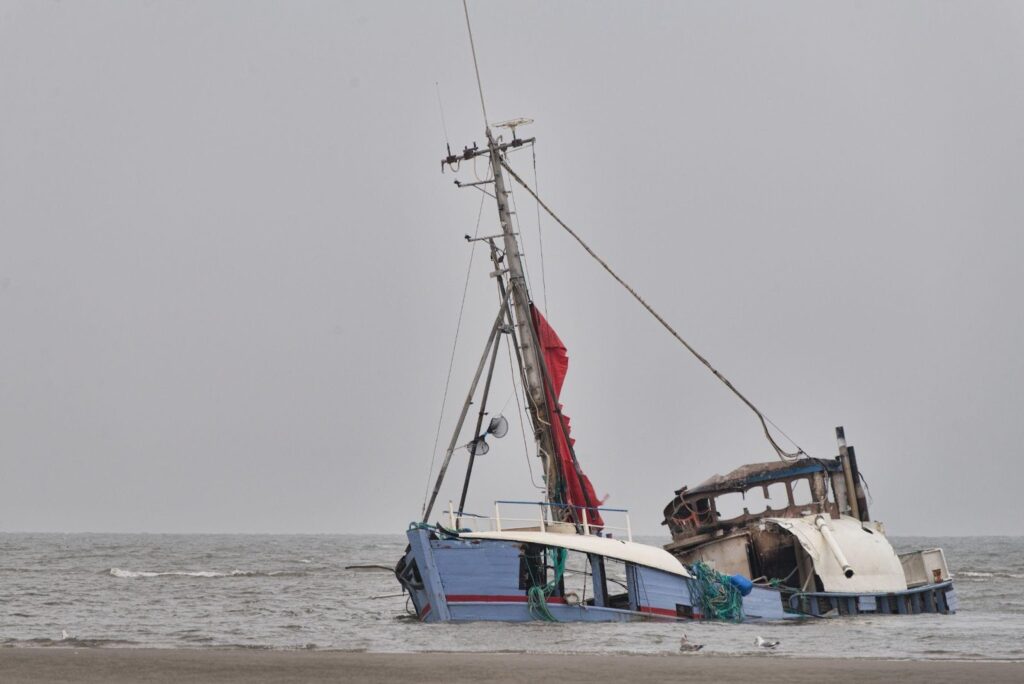 A damaged boat with visible dents and scratches, highlighting the aftermath of a boating accident and the potential hazards associated with watercraft incidents.