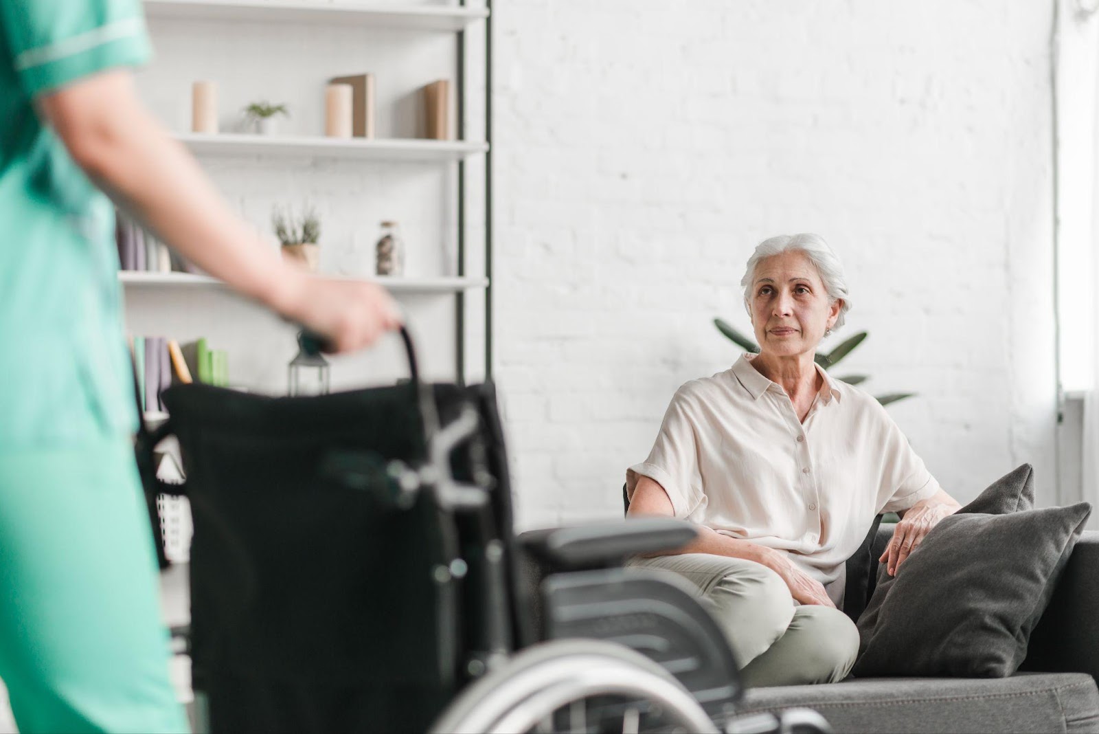 An elderly woman sitting alone in a nursing home, looking sad and isolated, highlighting the issue of neglect in elder care facilities.