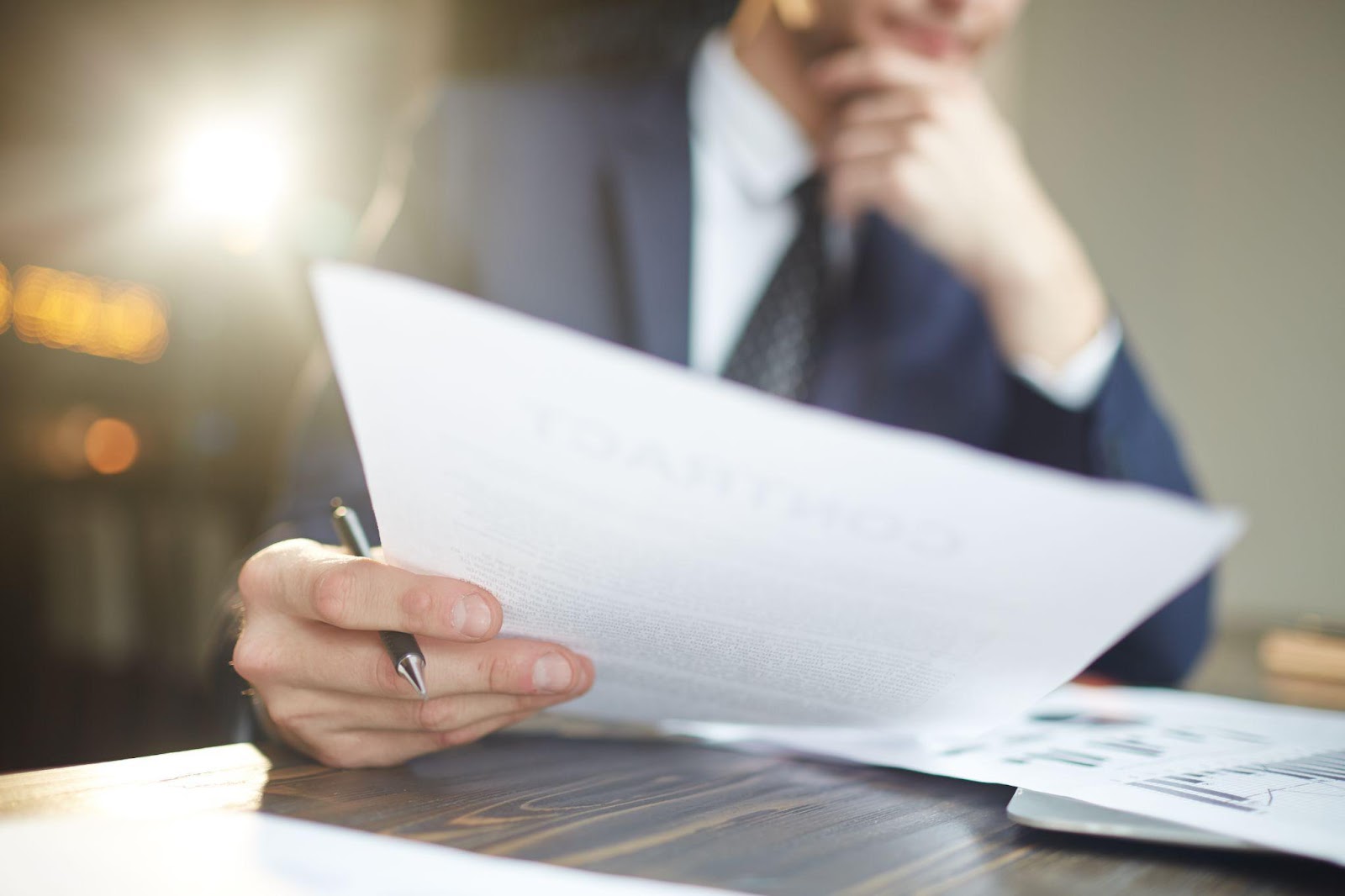 A lawyer reviewing documents at a desk, deeply focused on a case. This image connects to comparative negligence and how it affects damages in lawsuits, emphasizing the analysis required to determine fault and compensation.