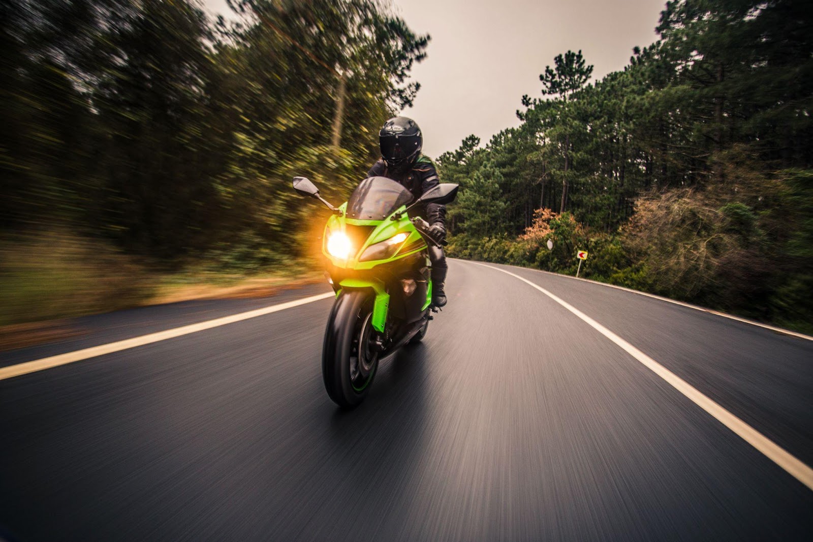 Motorcycle on an empty scenic road, emphasizing the importance of helmet laws and safety in preventing motorcycle accidents.