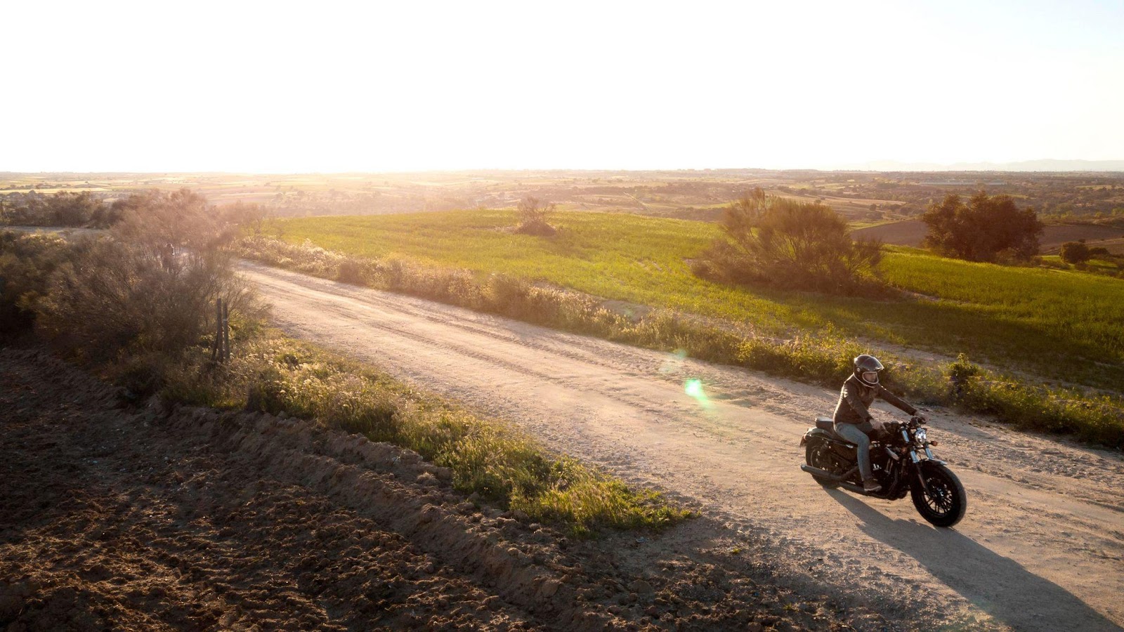 A motorcycle navigating a winding, hazardous road with steep curves, illustrating the risks of road hazards and their potential role in single-vehicle motorcycle accidents.