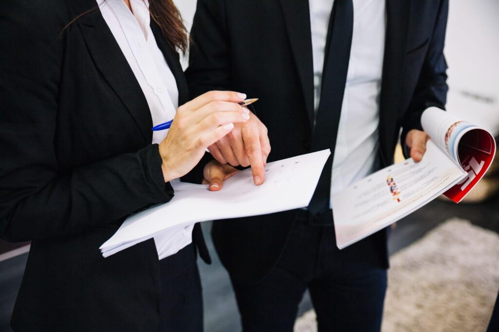 Lawyers discussing case details in a professional setting, symbolizing strategic preparation. This image relates to expert witness testimony, highlighting its role and importance in personal injury cases to provide specialized insights and strengthen legal arguments.