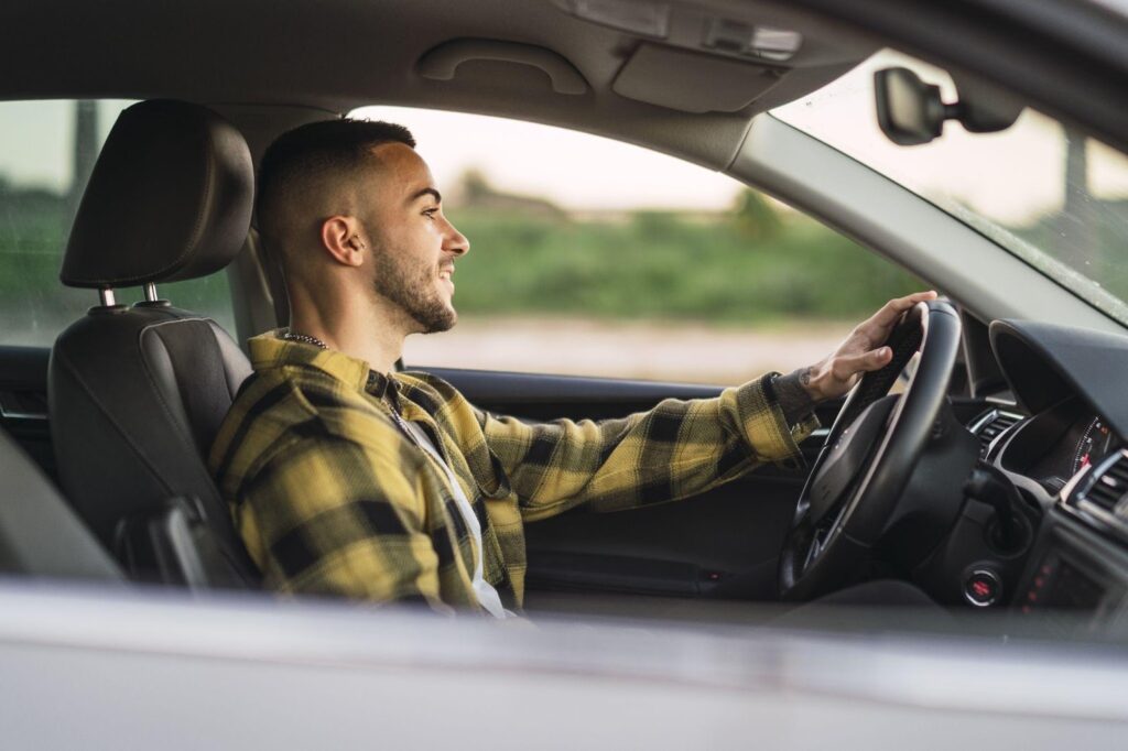 A driver in their car, focused on the road, representing everyday driving scenarios. This image relates to insurance coverage for uninsured and underinsured motorist claims, highlighting the protection available when the at-fault driver lacks sufficient insurance.