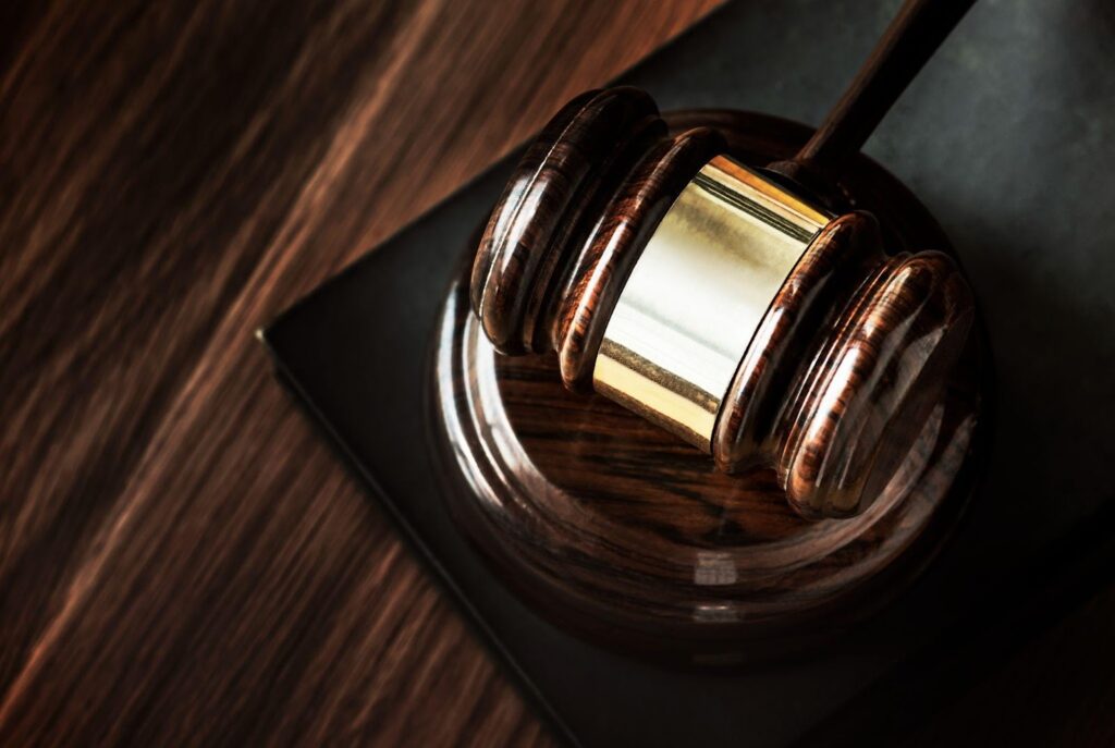 A gavel placed on a desk, symbolizing the legal process. This image relates to preparing for a deposition, offering tips and strategies for testifying effectively and confidently in legal proceedings.