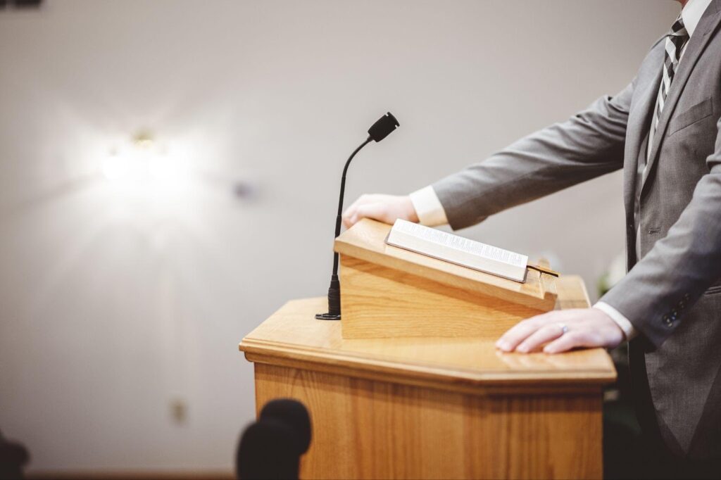 A person standing in a courtroom, symbolizing participation in a trial. This image relates to preparing for trial, focusing on the jury selection and voir dire process, which are crucial for ensuring a fair and impartial jury.