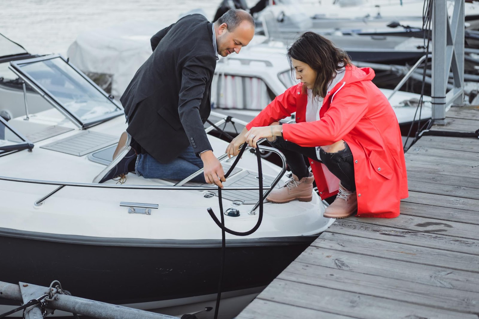 Two people on a dock working together to secure a boat, symbolizing recreational water activities. This image relates to recreational boating accidents, highlighting watercraft negligence and safety regulations in Alabama aimed at preventing such incidents.