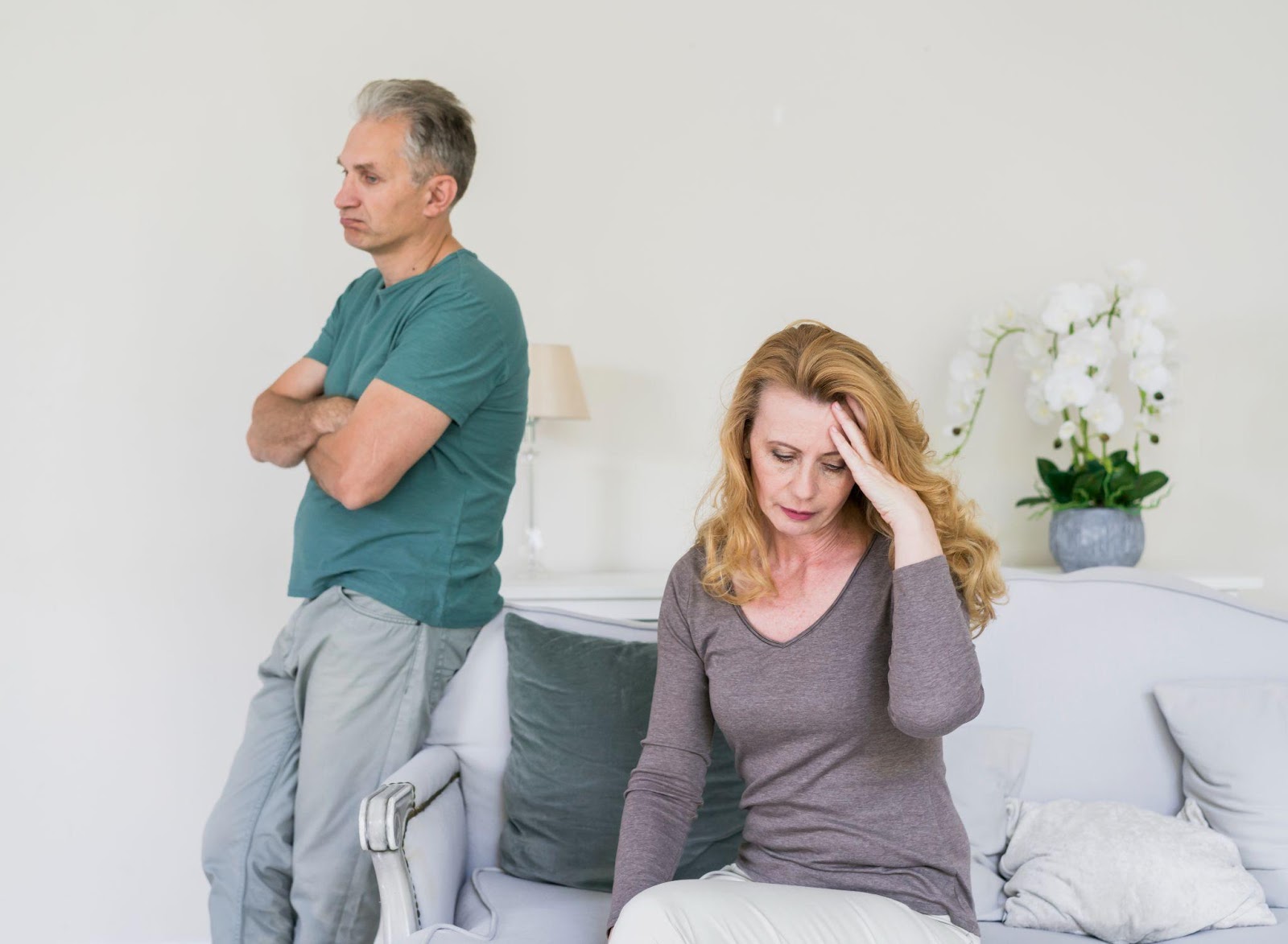 A stressed senior couple sitting apart in a home environment, symbolizing the emotional challenges of navigating divorce and offering context for '5 Tips for Dealing With Divorce Stress.