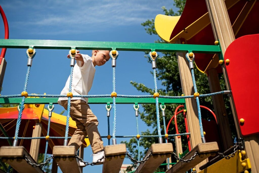 A child playing on a playground, symbolizing fun and activity. This image relates to playground accidents, emphasizing the importance of equipment safety and proper supervision to prevent injuries.