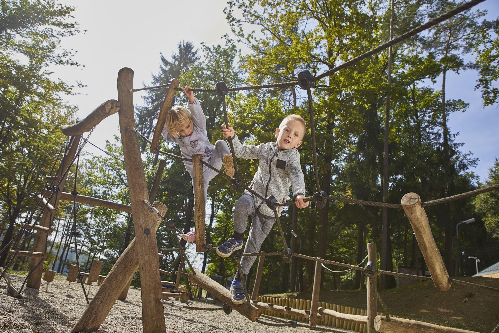 Two children playing on a playground, symbolizing activity and enjoyment. This image relates to playground injuries, highlighting issues of negligence, maintenance, and liability in ensuring a safe environment for children.