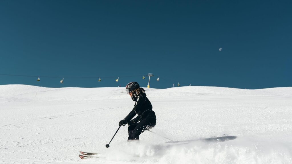 A skier navigating down a slope, symbolizing winter sports and adventure. This image relates to ski resort accidents, emphasizing negligence, injuries, and the liability of resorts in ensuring safety for visitors.