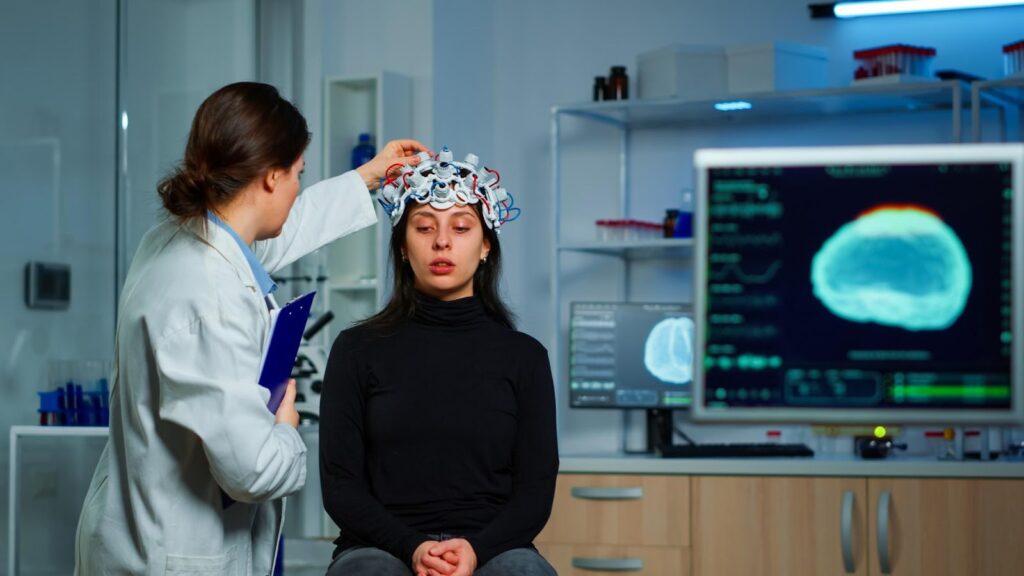 A doctor examining a patient’s brain scan, symbolizing medical care. This image relates to traumatic brain injuries, emphasizing the importance of cognitive rehabilitation and support in recovery and improving quality of life.