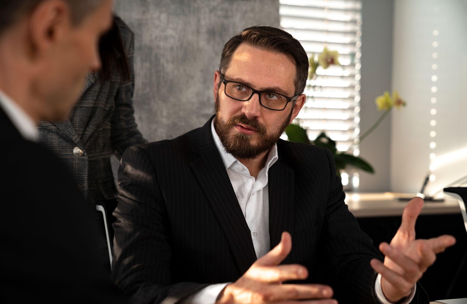 A lawyer discussing documents with a client, symbolizing legal guidance. This image relates to the consequences of violating custody orders in Alabama, emphasizing legal actions and potential remedies for enforcing custody agreements.