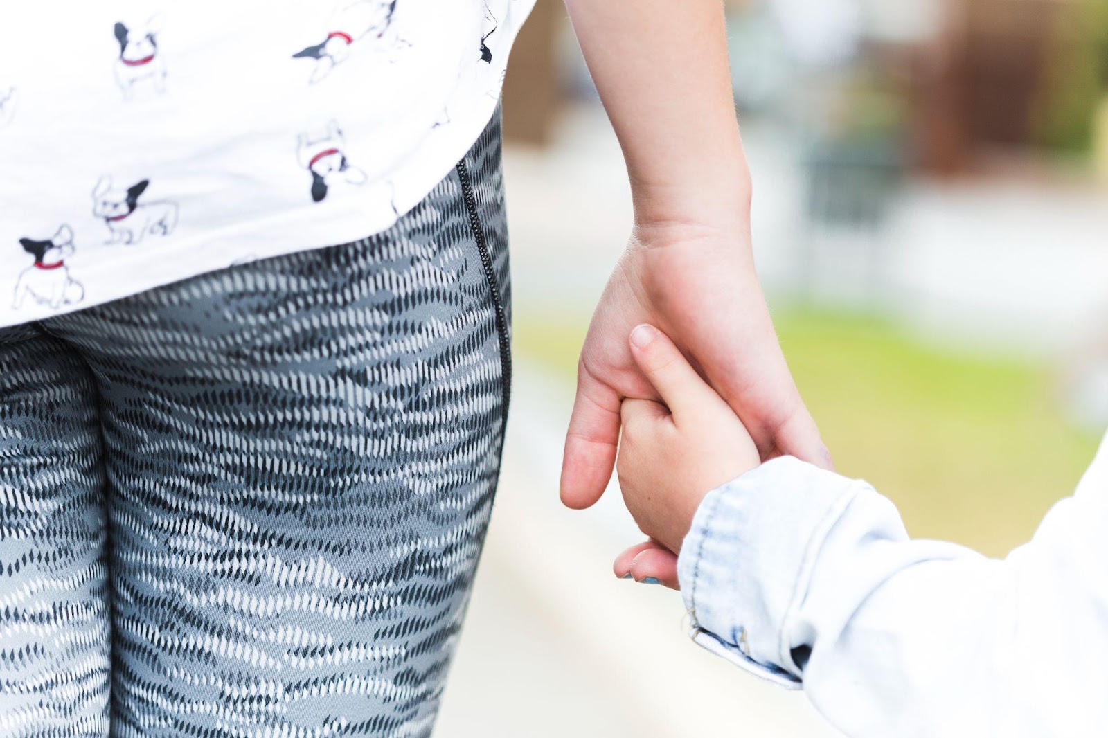 A close-up of a parent and child holding hands, symbolizing care and connection. This image relates to the best interest of the child in Alabama custody cases, highlighting the guiding principle in custody decisions.