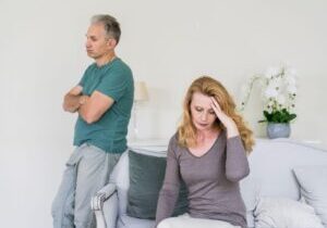 A stressed senior couple sitting apart in a home environment, symbolizing the emotional challenges of navigating divorce and offering context for '5 Tips for Dealing With Divorce Stress.