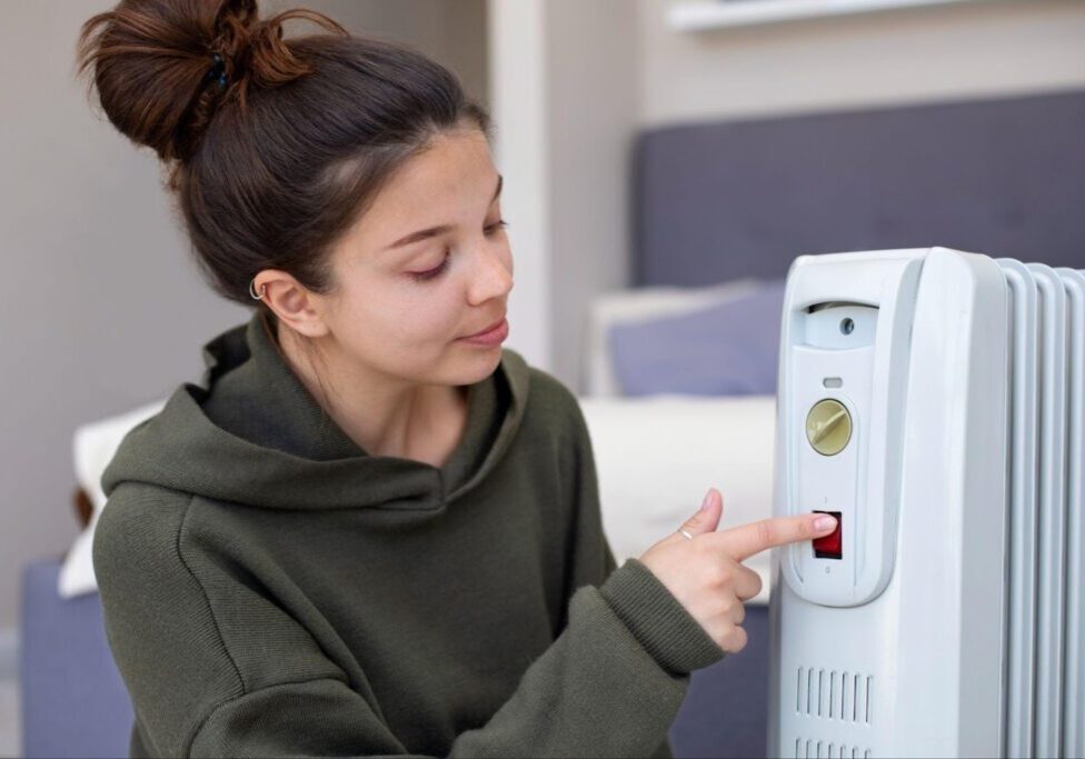 A woman adjusting a heater device, symbolizing the importance of proper maintenance. This image relates to carbon monoxide poisoning, highlighting the liability of property owners and landlords in ensuring the safety of tenants by maintaining appliances and ventilation systems.