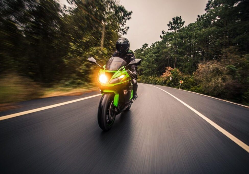 Motorcycle on an empty scenic road, emphasizing the importance of helmet laws and safety in preventing motorcycle accidents.