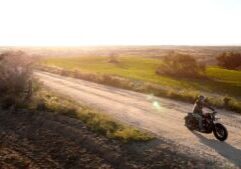 A motorcycle navigating a winding, hazardous road with steep curves, illustrating the risks of road hazards and their potential role in single-vehicle motorcycle accidents.