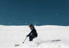 A skier navigating down a slope, symbolizing winter sports and adventure. This image relates to ski resort accidents, emphasizing negligence, injuries, and the liability of resorts in ensuring safety for visitors.