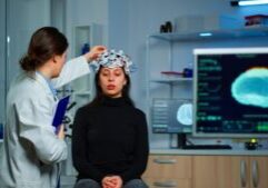 A doctor examining a patient’s brain scan, symbolizing medical care. This image relates to traumatic brain injuries, emphasizing the importance of cognitive rehabilitation and support in recovery and improving quality of life.